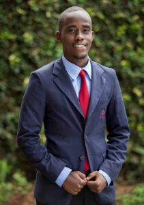 a male ihti student in college attire poses for a photo jpg