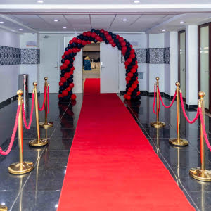 A decorated entrance to an event hall with red carpet jpg